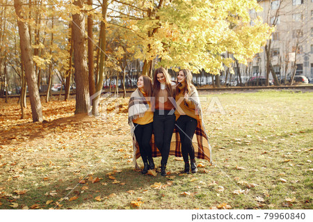 Elegant and stylish girls in a autumn park 79960840