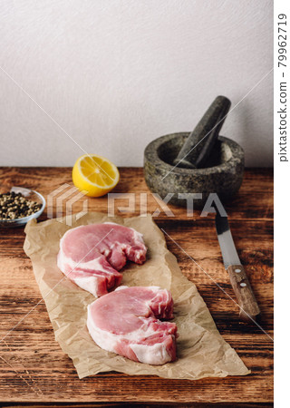 Two pork loin steaks with lemon and peppercorn 79962719