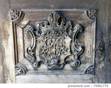 Detail of a beautiful old wooden door of Church Maria Strassengel, a 14th century Gothic pilgrimage church in the town of Judendorf Strassengel near Graz, Styria region, Austria Detail of a beautiful old wooden door of Church Maria Strassengel, a 14th century Gothic pilgrimage church in the town of Judendorf Strassengel near Graz, Styria region, Austria 79962774