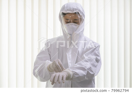 male nurse or doctor wearing ppe suit and facemask perform Coronavirus COVID-19 PCR test. Doctor puts on protective gloves and wearing ppe protection suit with face shield for fighting Covid-19. male nurse or doctor wearing ppe suit and facemask perform Coronavirus COVID-19 PCR test. Doctor puts on protective gloves and wearing ppe protection suit with face shield for fighting Covid-19. 79962794
