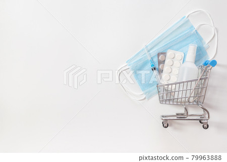 Grocery cart with medicines on a white background. Medical masks, sanitizer, pills. Coronavirus, covid-19 concept. Pharmacy shopping. Grocery cart with medicines on a white background. Medical masks, sanitizer, pills. Coronavirus, covid-19 concept. Pharmacy shopping. 79963888
