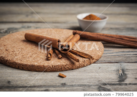 Cinnamon sticks on wooden background. Cinnamon sticks on wooden background. 79964025