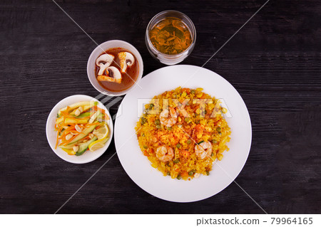 fried rice with peas and seafood, green tea, sauce and salad fried rice with peas and seafood, green tea, sauce and salad 79964165