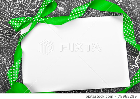 satin ribbon. Background grey, texture of cracked paint on old board. Copy space satin ribbon. Background grey, texture of cracked paint on old board. Copy space 79965289