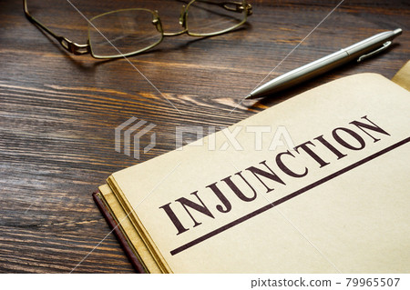 Injunction word on the top of page and pen. 79965507