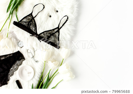 Flat lay stylish, sexy, black lingerie, accessories on a white background. Top view. Flat lay stylish, sexy, black lingerie, accessories on a white background. Top view. 79965688
