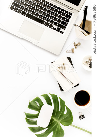 Home office workspace mockup with laptop, tropical leaves Monstera, clipboard, notebook and accessories on white background. Flat lay, top view Home office workspace mockup with laptop, tropical leaves Monstera, clipboard, notebook and accessories on white background. Flat lay, top view 79965690
