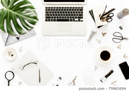 Home office workspace mockup with laptop, tropical leaves Monstera, clipboard, notebook and accessories on white background. Flat lay, top view Home office workspace mockup with laptop, tropical leaves Monstera, clipboard, notebook and accessories on white background. Flat lay, top view 79965694