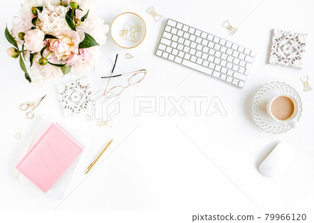 Flat lay women's office desk. Female workspace with computer, pink peonies bouquet, accessories on white background. Top view feminine background. 79966120