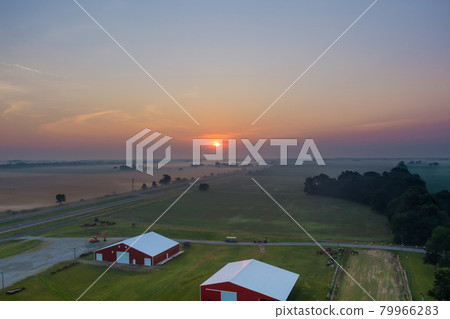 Beautiful misty village landscape meadow with fog early morning sunrise Beautiful misty village landscape meadow with fog early morning sunrise 79966283