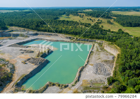 Aerial view in Open pit stone extraction in the canyon with deep green lake Aerial view in Open pit stone extraction in the canyon with deep green lake 79966284