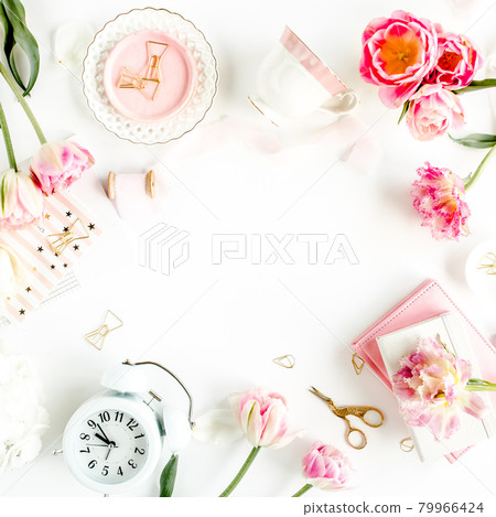 Fashion blog pink style desk with accessories, tulip flowers, scissors, coffee cup on white background. Flat lay. Top view. 79966424