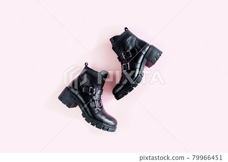 Black female boots on white background. Flat lay, top view minimal background. Fashion blog or magazine concept. 79966451