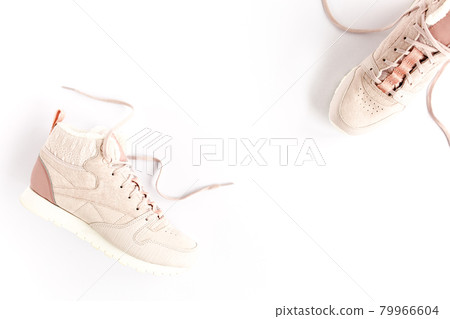 Pink female sneakers on white background. Flat lay, top view minimal background. Fashion blog or magazine concept. 79966604