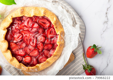 Homemade galette with strawberries on white marble background Homemade galette with strawberries on white marble background 79968222