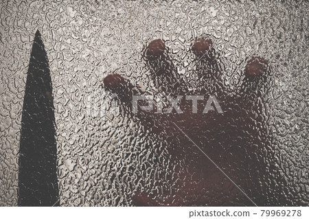 Knife in hand. Aggressive tin attack. Hacking attempt. The criminal behind the glass. Agony crooked hand. Criminal and victim, resisting the hands of the victim and attacking hand with a knife 79969278