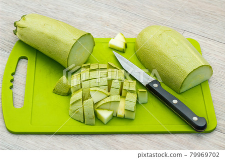 Zucchini sliced on a green cutting board. Fresh, ripe, tasty, natural vegetable 79969702