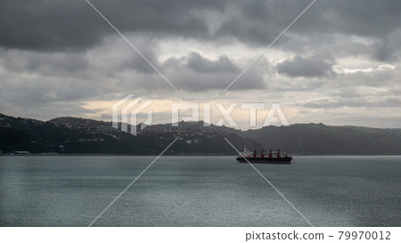 Transport ship sailing on ocean during overcast day, Shot taken on ferry heading from North to South Island, New Zealand Transport ship sailing on ocean during overcast day, Shot taken on ferry heading from North to South Island, New Zealand 79970012
