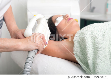 Laser epilation and cosmetology in beauty salon. Cosmetology, spa and hair removal concept. 79970150