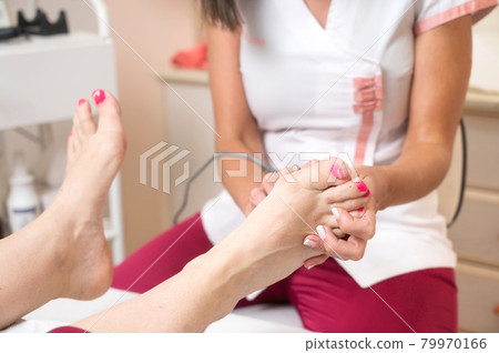 Callus peeling using professional pedicure drill machine. Spa foot treatment. Removing hard Callus peeling using professional pedicure drill machine. Spa foot treatment. Removing hard 79970166