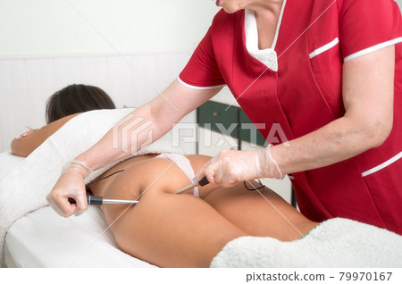Woman having cosmetic galvanic beauty treatment in spa. Therapist applying low frequency current 79970167
