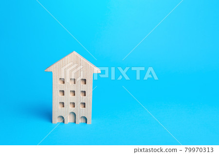 Wooden multi-storey house on a blue background. Buying and selling real estate. Housing, realtor services. Renovation and home improvement. Mortgage loan. Building maintenance. Wooden multi-storey house on a blue background. Buying and selling real estate. Housing, realtor services. Renovation and home improvement. Mortgage loan. Building maintenance. 79970313