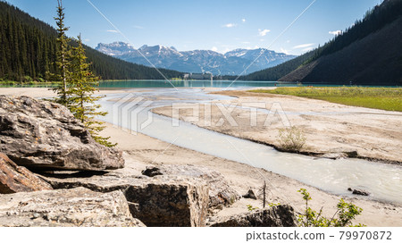 Picturesque mountain scenery with turquoise lake mountains and castle like hotel on its end. Shot in Lake Louise area, Banff National Park, Canada 79970872