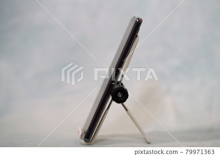 Smartphone stand and smartphone standing on the smartphone stand 79971363