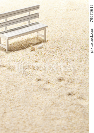 Summer remnants footprints and white bench Summer remnants footprints and white bench 79973612