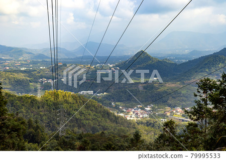 High-voltage electricity towers winding through the mountains 79995533
