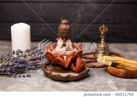 Aromatherapy and spa. Buddha figurine with incense smoke. Religious Aromatherapy and spa. Buddha figurine with incense smoke. Religious 80031764