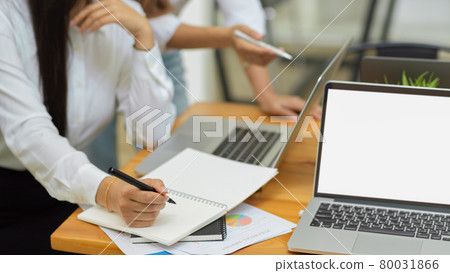 Business workers talking about the business result via laptop at office Business workers talking about the business result via laptop at office 80031866