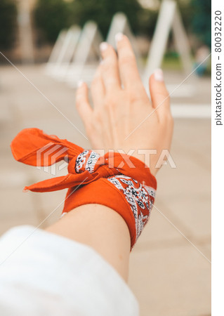 Hand of millennial hipster woman with red bandana scarf. Retro style. Hand of millennial hipster woman with red bandana scarf. Retro style. 80032220