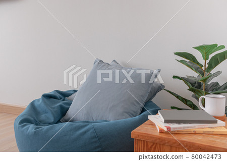 Bean bag in a clear living room with wooden floor and clear white wall. 80042473