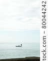 A fishing boat floating in the sea 80044242
