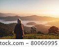 Young woman travelers looking at the sunrise and the sea of mist on the mountain in the morning, Travel lifestyle concept 80060995