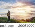 Young woman travelers looking at the sunrise and the sea of mist on the mountain in the morning, Travel lifestyle concept 80061000