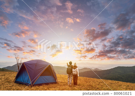 Young couple traveler looking landscape at sunset and camping on mountain, Adventure travel lifestyle concept Young couple traveler looking landscape at sunset and camping on mountain, Adventure travel lifestyle concept 80061021