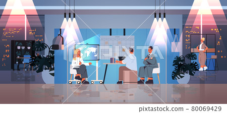 tired businesspeople working together in creative coworking center teamwork concept dark night office interior 80069429