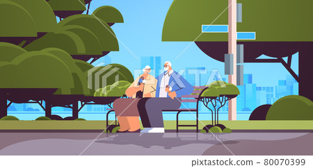 senior couple sitting on bench and eating ice cream happy grandparents spending time together in park 80070399
