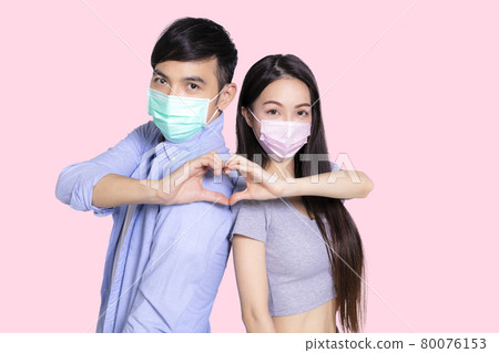 Young couple wearing medical mask background Young couple wearing medical mask background 80076153