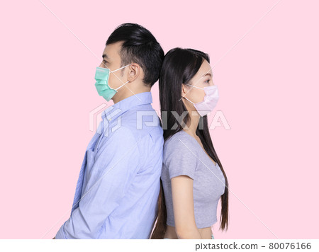 couple wearing medical mask standing back to back couple wearing medical mask standing back to back 80076166