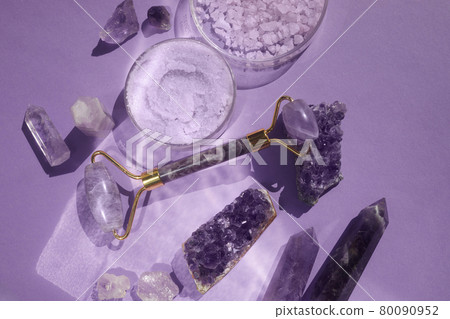 Amethyst crystals Gua sha roller massage scraper and beauty product. Moisturizer and skincare tools. Wellness concept. Amethyst crystals Gua sha roller massage scraper and beauty product. Moisturizer and skincare tools. Wellness concept. 80090952