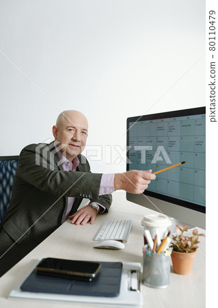 Businessman working on computer at office Businessman working on computer at office 80110479