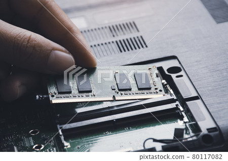 Technician install new RAM (Random-access memory) to memory slot on laptop motherboard 80117082