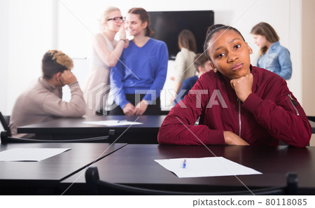sad girl student feeling uncomfortable at break between classes sad girl student feeling uncomfortable at break between classes 80118085