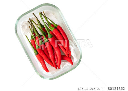 Top view red chilli or Jinda chilli of Thailand. Fresh red chilli in small glass container, supported by kitchen towel paper, isolated image on white background. Top view red chilli or Jinda chilli of Thailand. Fresh red chilli in small glass container, supported by kitchen towel paper, isolated image on white background. 80121862
