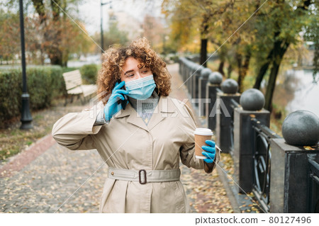 distance communication phone call woman mask park 80127496