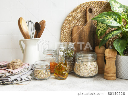 Kitchen utensils, tools and dishware on on the background white tile wall. Kitchen utensils, tools and dishware on on the background white tile wall. 80150228