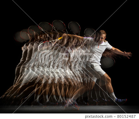 Young man, professional tennis player in motion and action isolated on dark background. Stroboscope effect. Young man, professional tennis player in motion and action isolated on dark background. Stroboscope effect. 80152487